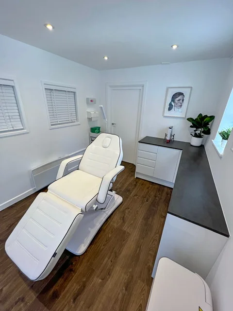 The treatment room at Virtuoso Aesthetics, with the treatment couch and the worktop.